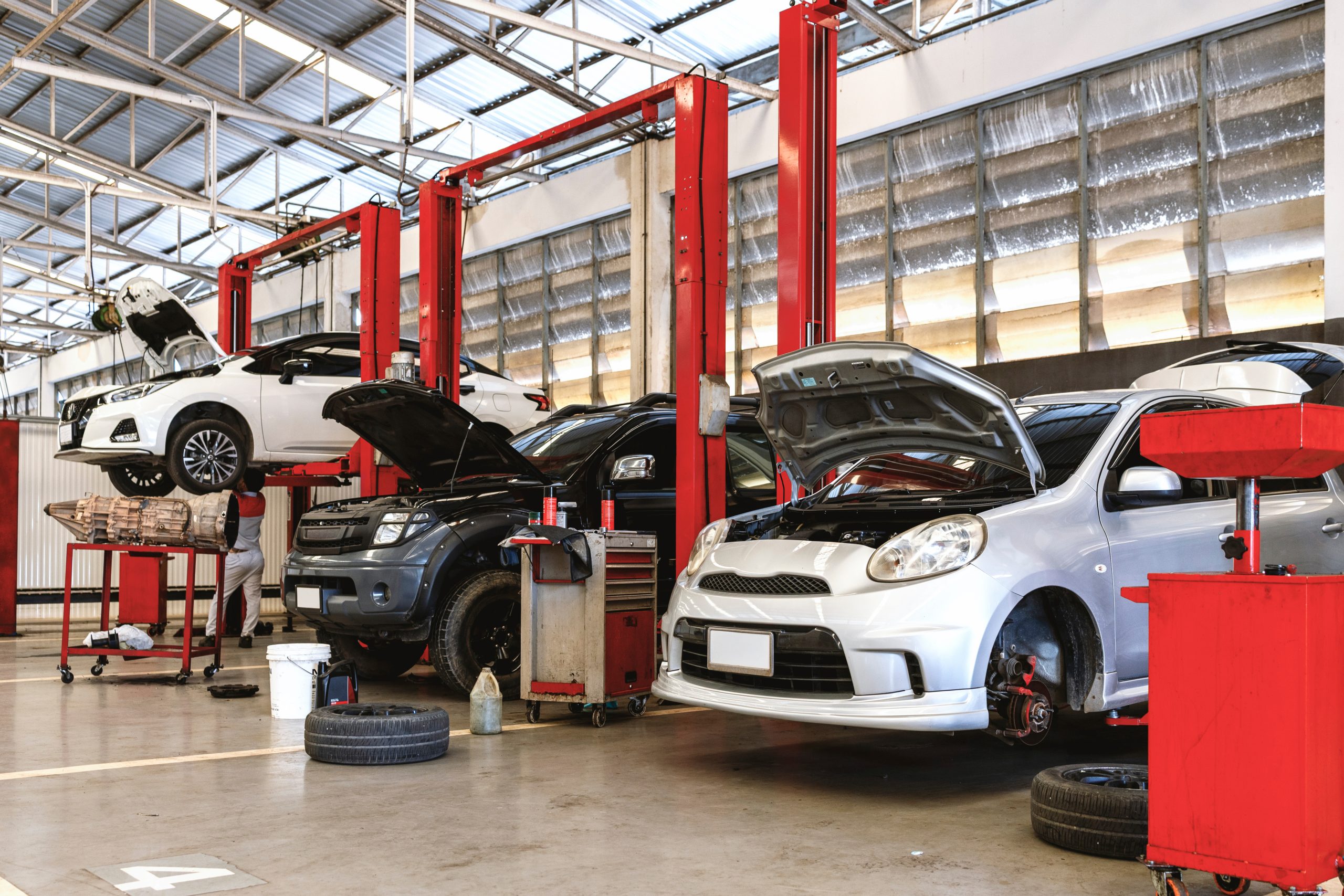 Auto Repair Workshop with Cars on Hydraulic Lifts