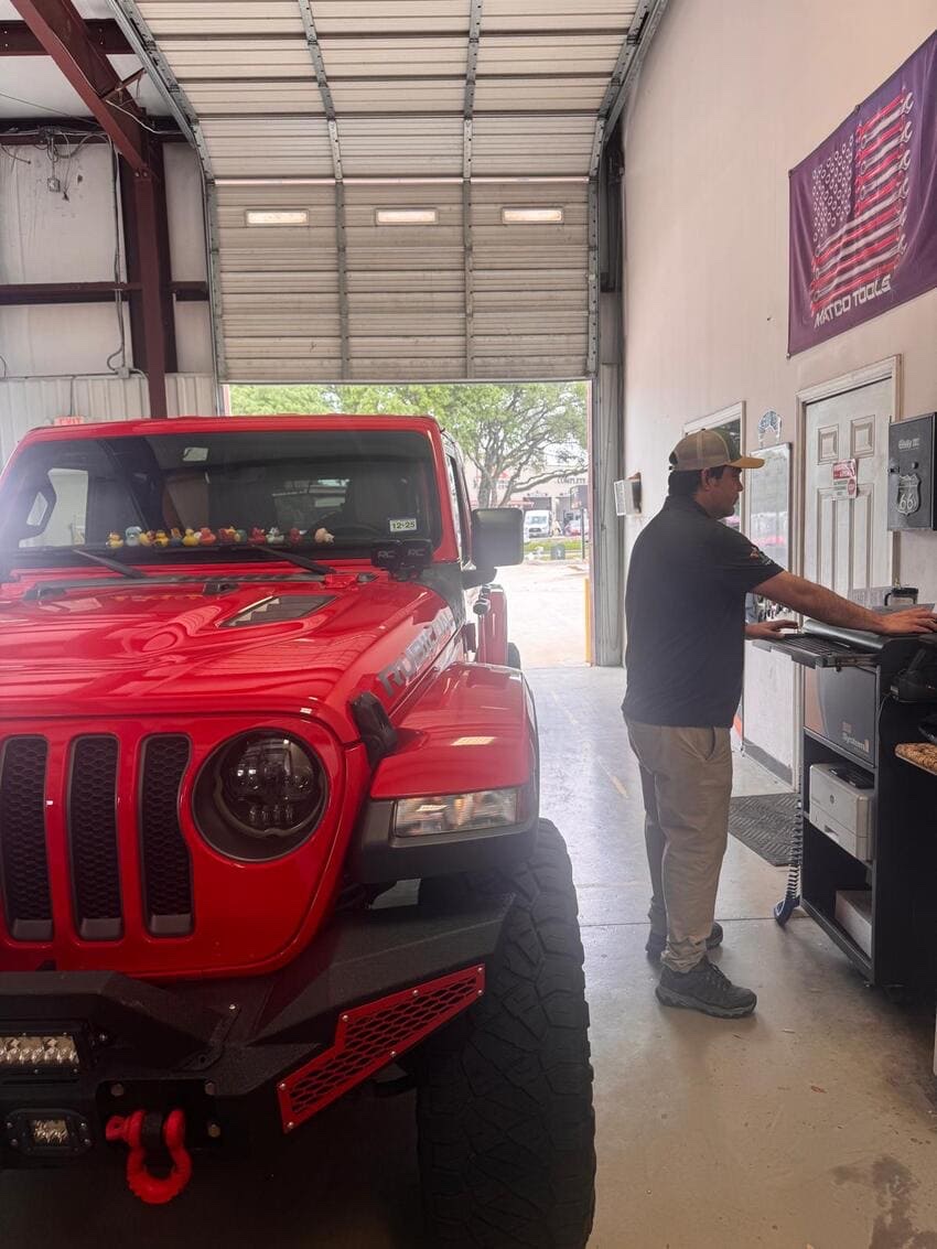 Jeep Wrangler in the service bay at Northwest Express Auto Care