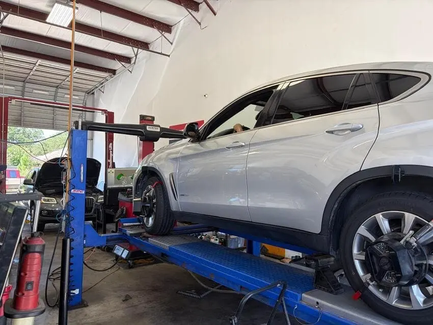 SUV on the alignment rack at Northwest Express Auto Care in Katy, TX