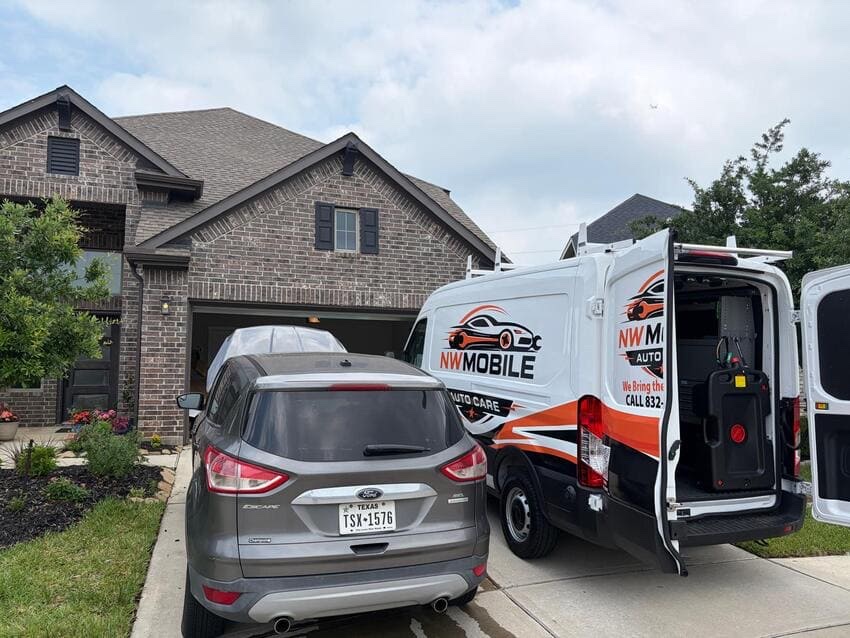 NW Mobile Auto Care van servicing a customer vehicle in a Katy, TX driveway