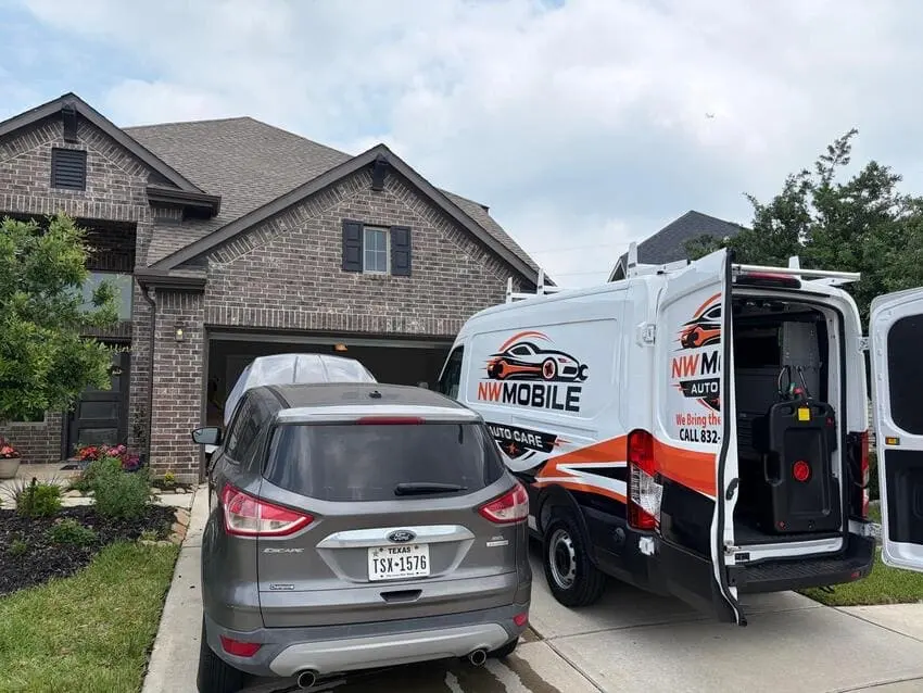NW Mobile Auto Care van servicing a customer vehicle in a Katy, TX driveway